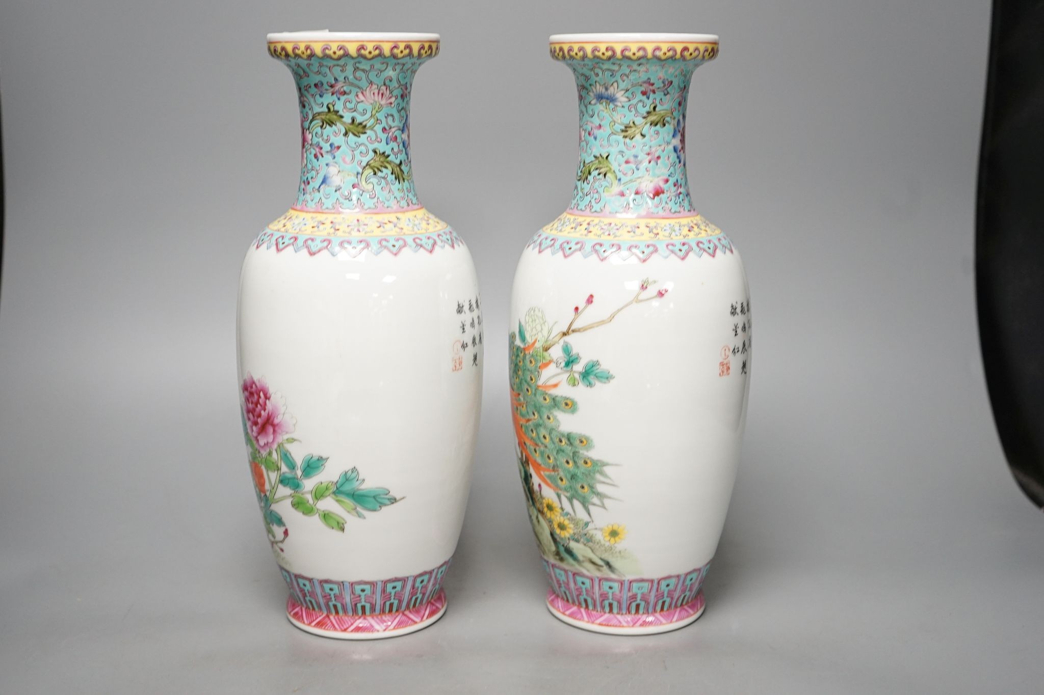 A pair of Chinese famille rose vases decorated with peacocks, 31cm
